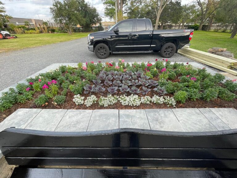 A long flowering border planted along a residential driveway